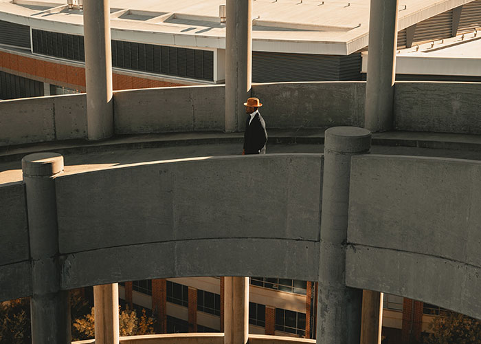 man walking down concrete ramp